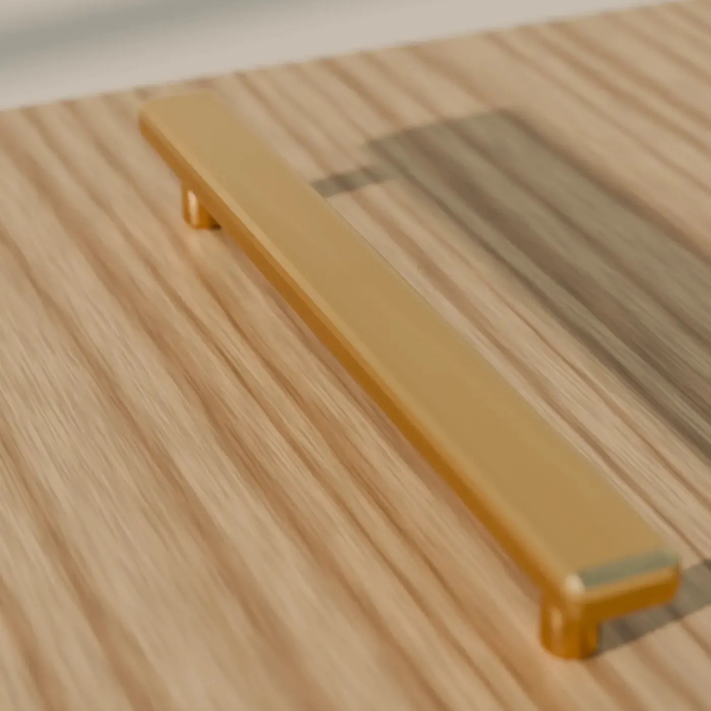 Concept render of a brushed brass bar handle on oak