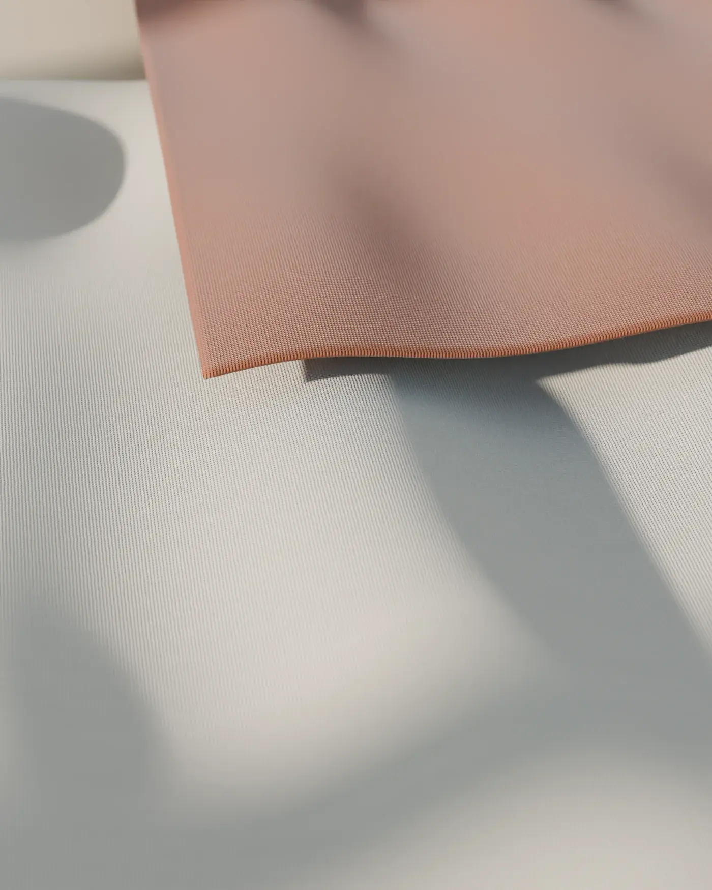 Loosely gathered natural and rust linen, the weave catching low light