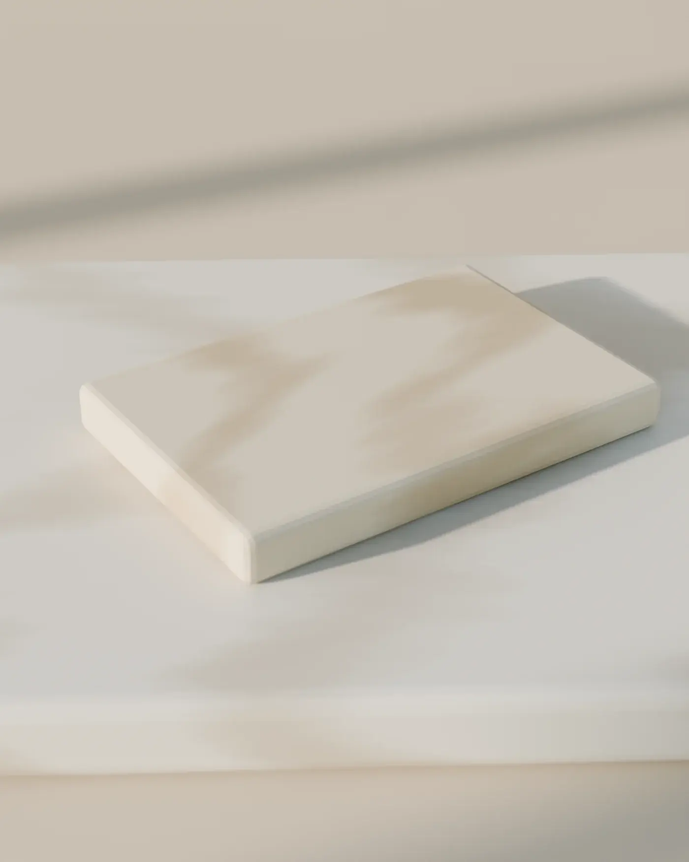 A honed limestone slab with an eased edge and a small travertine offcut